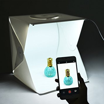 Person taking photo with phone in front of a pop up lightbox