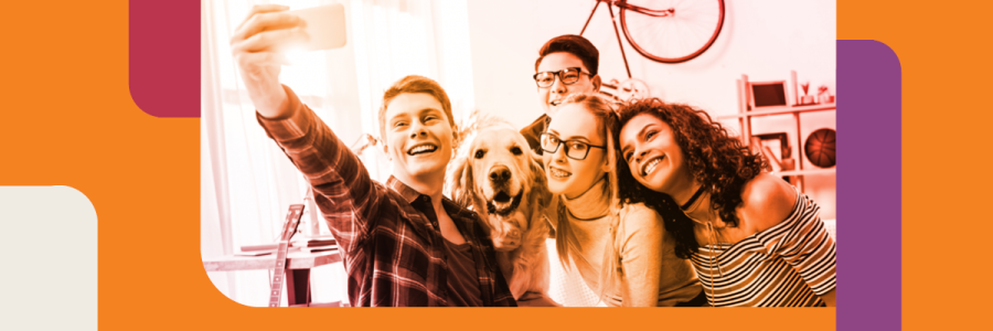 Image of teens taking a selfie with a dog