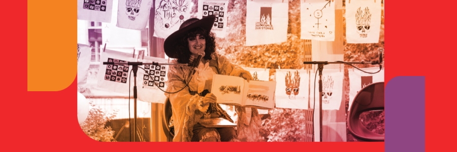 A person dressed up in drag reading a picture book to a crowd