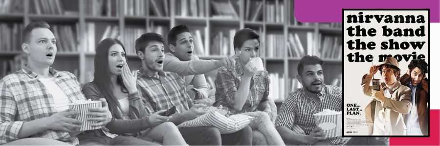 A group of adults watching a film.