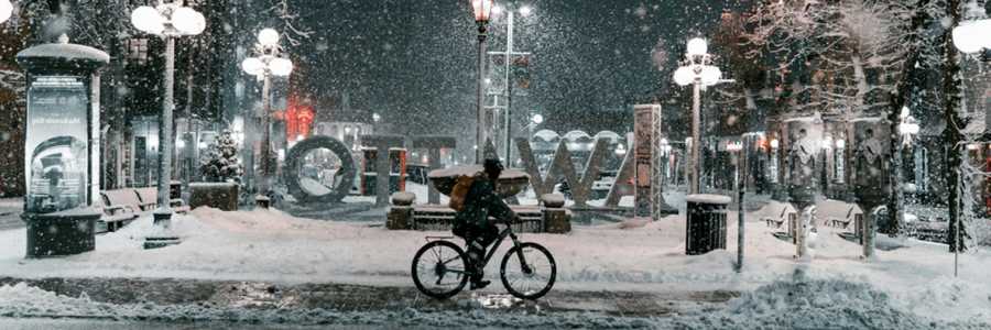 A person riding a bike in Ottawa in the snow A person riding a bike in Ottawa in the snow