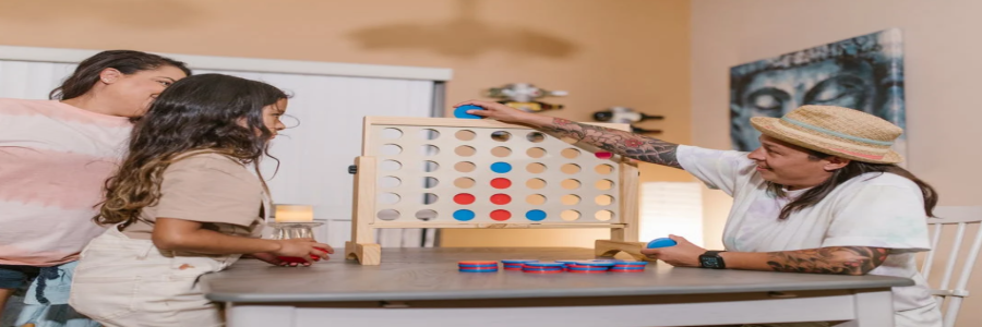 Adult playing board game with children Adult playing board game with children