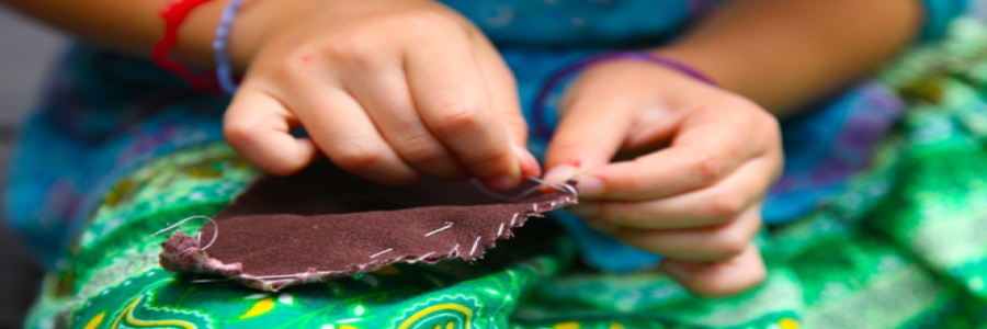 girl sewing by hand