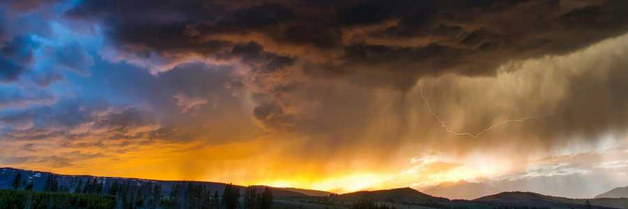 Sun and storm landscape over mountains