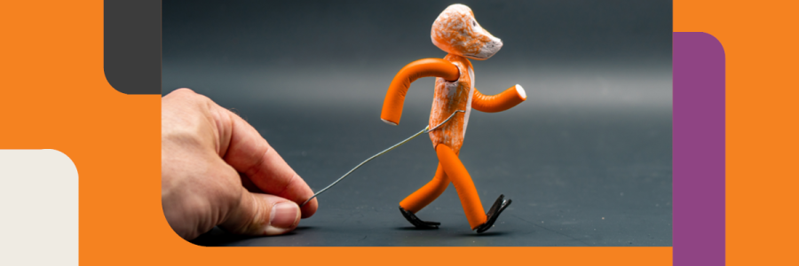 An image of a small humaoid figurine being animated by a human hand